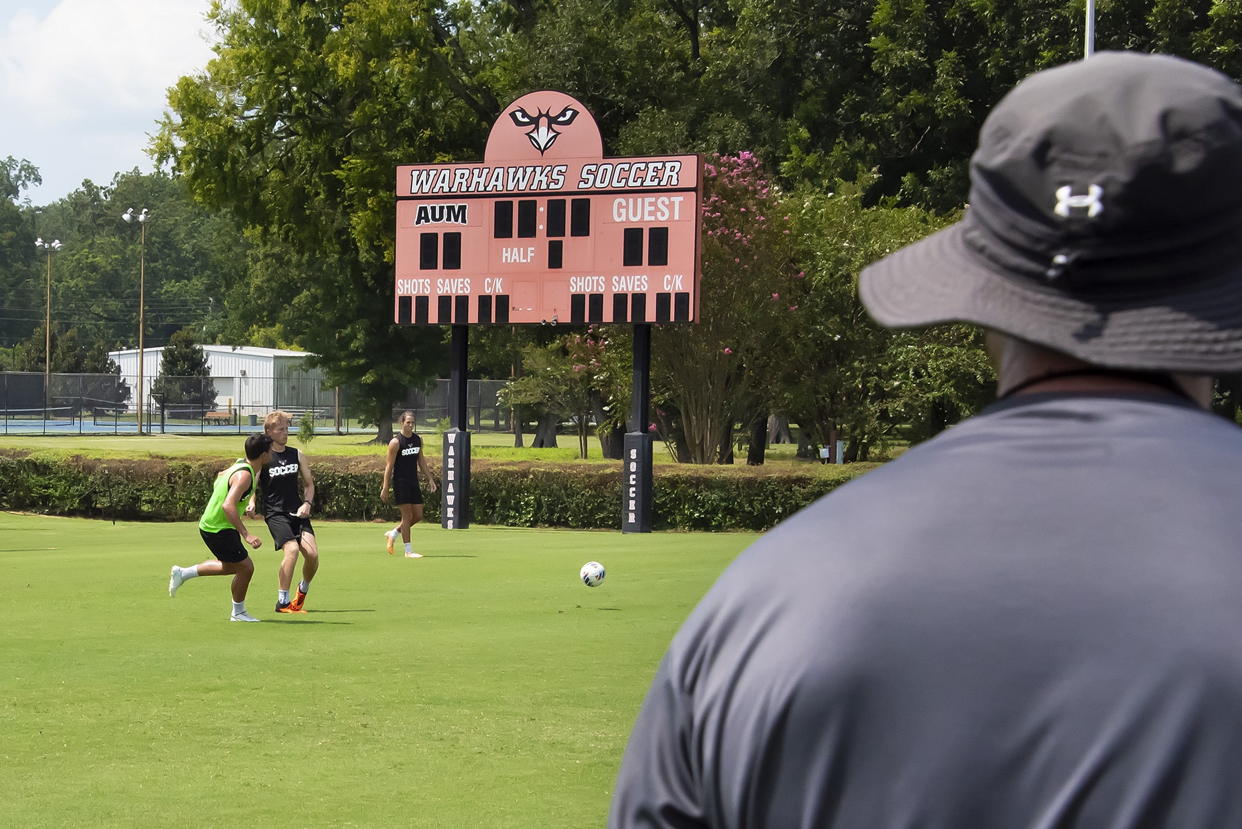 a group of people playing frisbee in a field