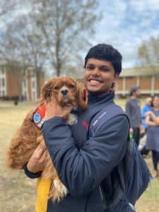 a person standing next to a stuffed animal