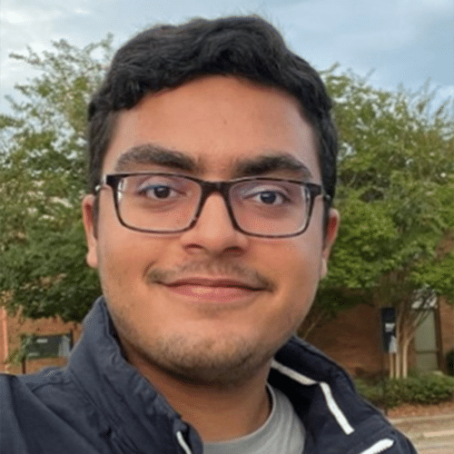 a man wearing glasses and smiling at the camera a man wearing glasses and smiling at the camera