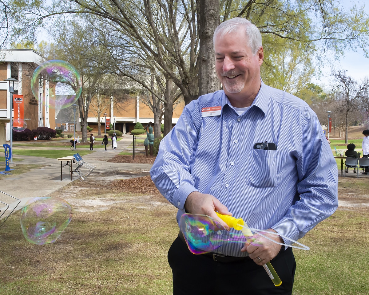 Phill Johnson, Dean of the Library, plays with bubbles on the Quad as part of GEARSEF.