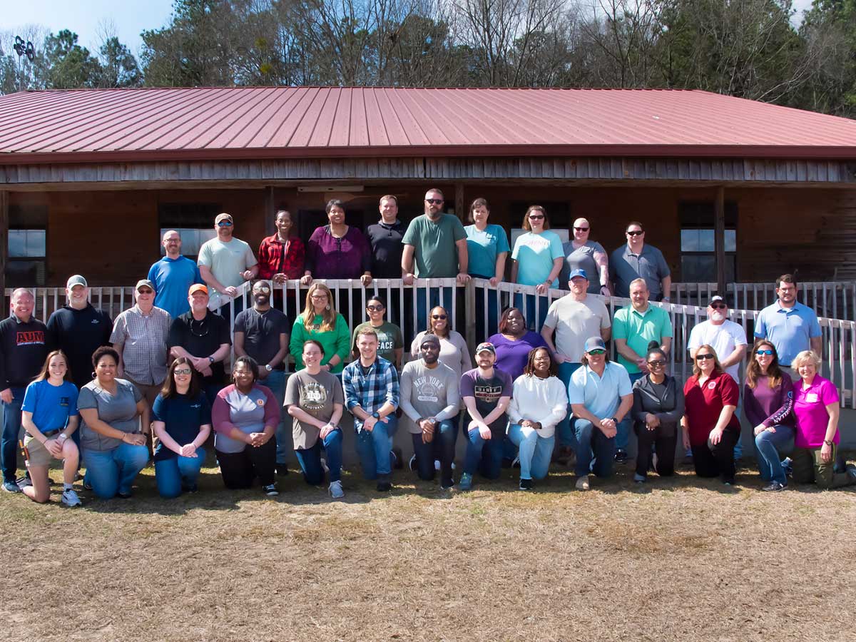 a group of people standing in front of a crowd posing for the camera