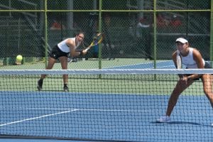 a person hitting a ball with a racket on a court