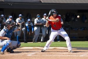 a baseball player swinging a bat at a ball