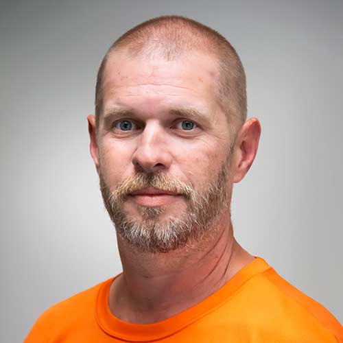 a man wearing an orange shirt