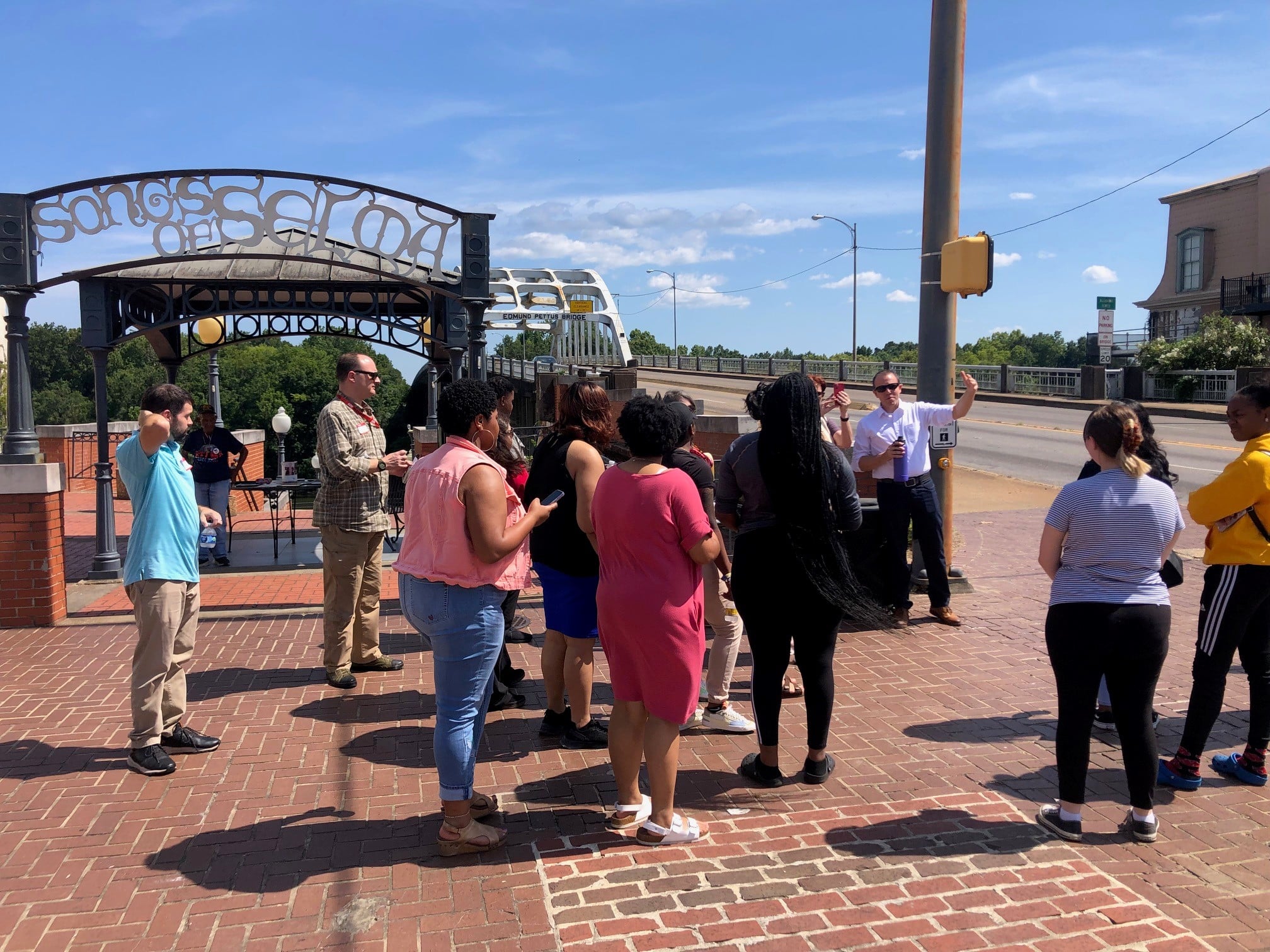 a group of people standing on a sidewalk