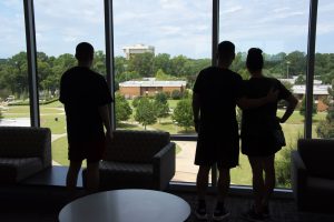 a couple of people that are standing in front of a window