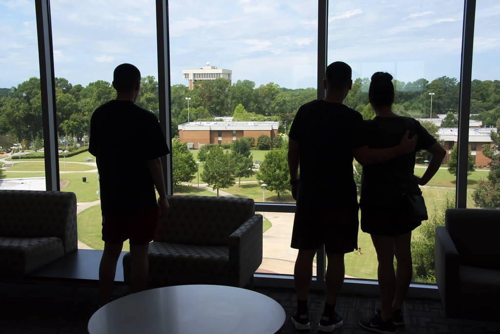 a couple of people that are standing in front of a window