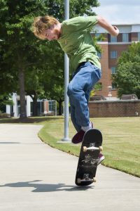 Garrison Campbell shows off a trick on a skateboard.