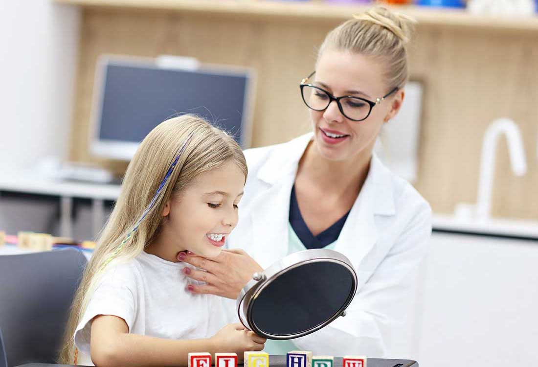 Auburn University at Montgomery speech-language pathology student helps a child with mirror speech therapy
