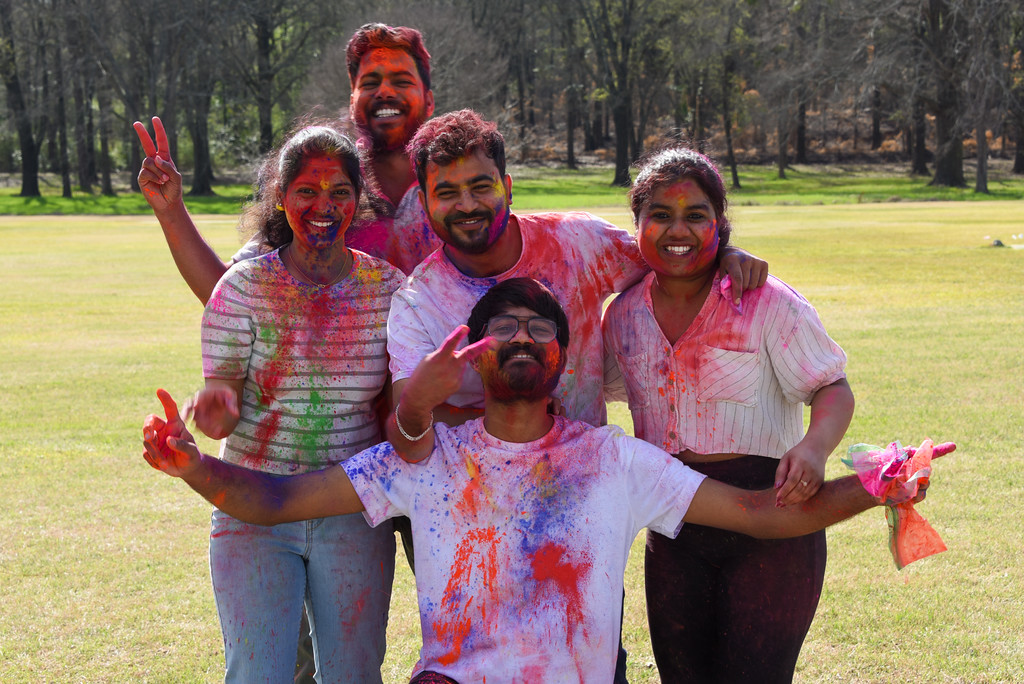 Students were covered in colored powders after the Holi celebration.