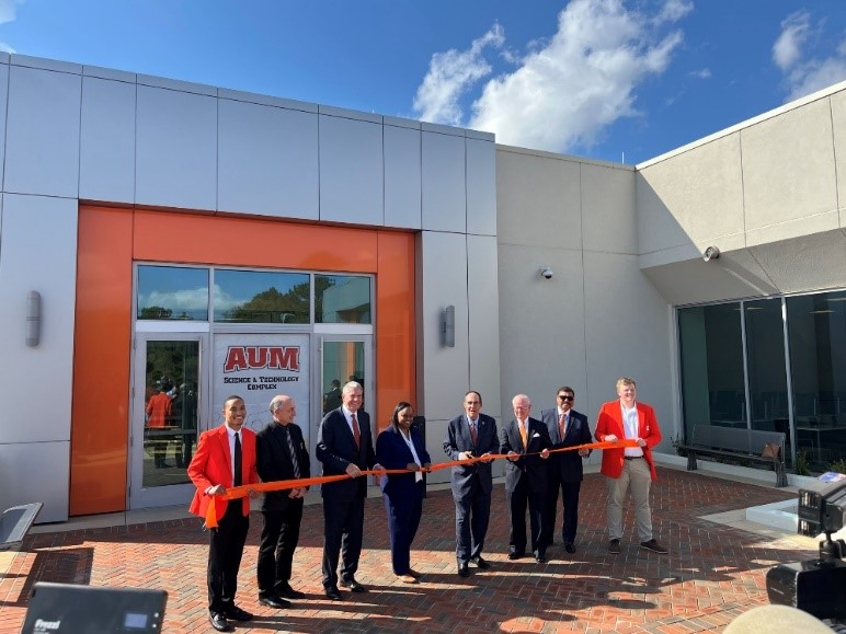 Chancellor Stockton and several AU Board of Trustees cut the ribbon in front of the Science and Technology Complex.