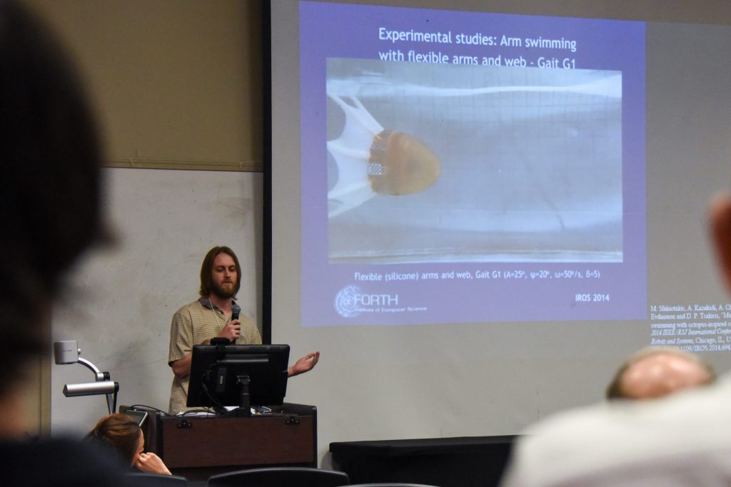 A Student Explains His Team's Work During The College Of Sciences Student Research Symposium
