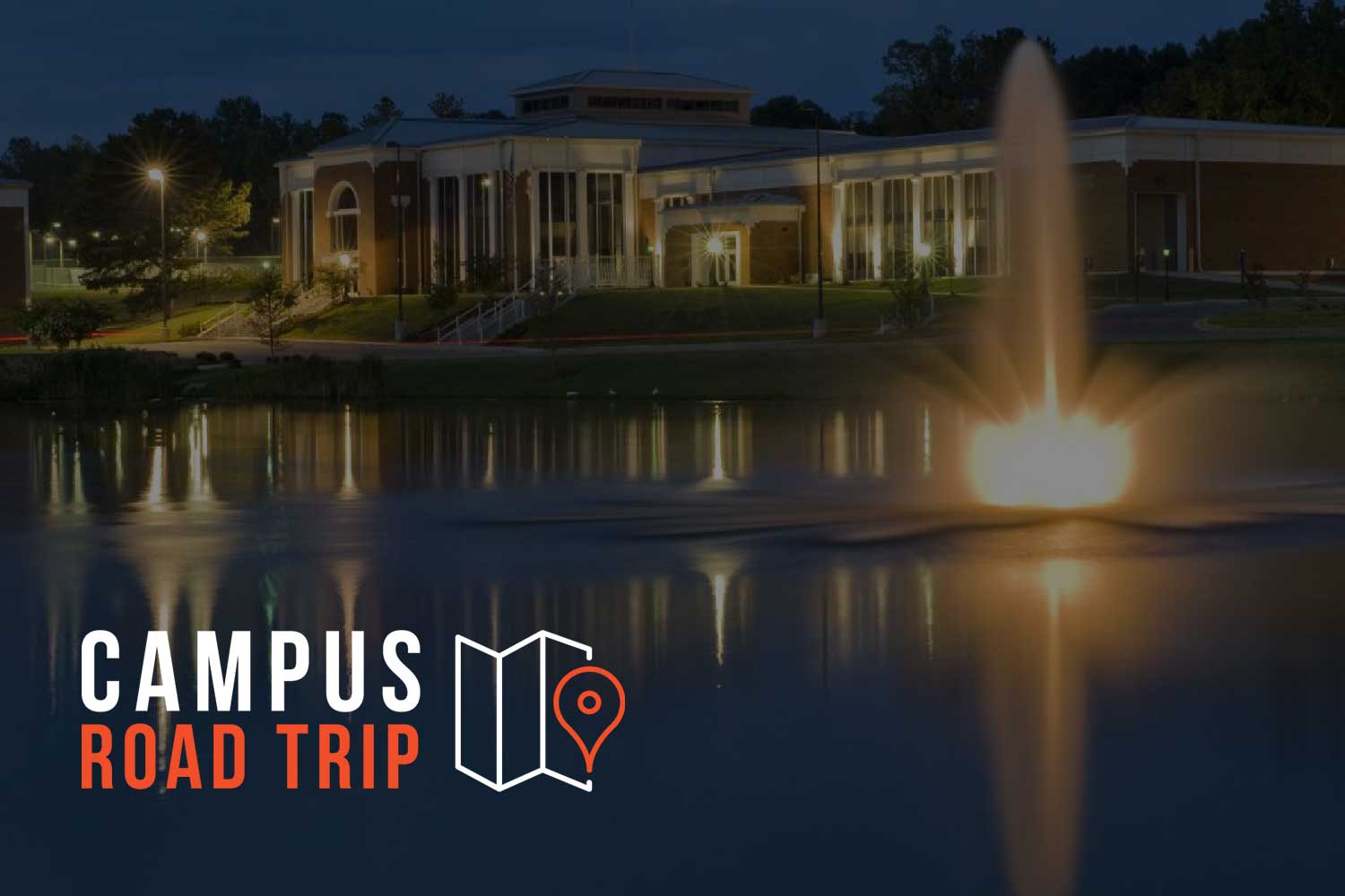 Auburn University at Montgomery campus at night with a bright fountain in the foreground.