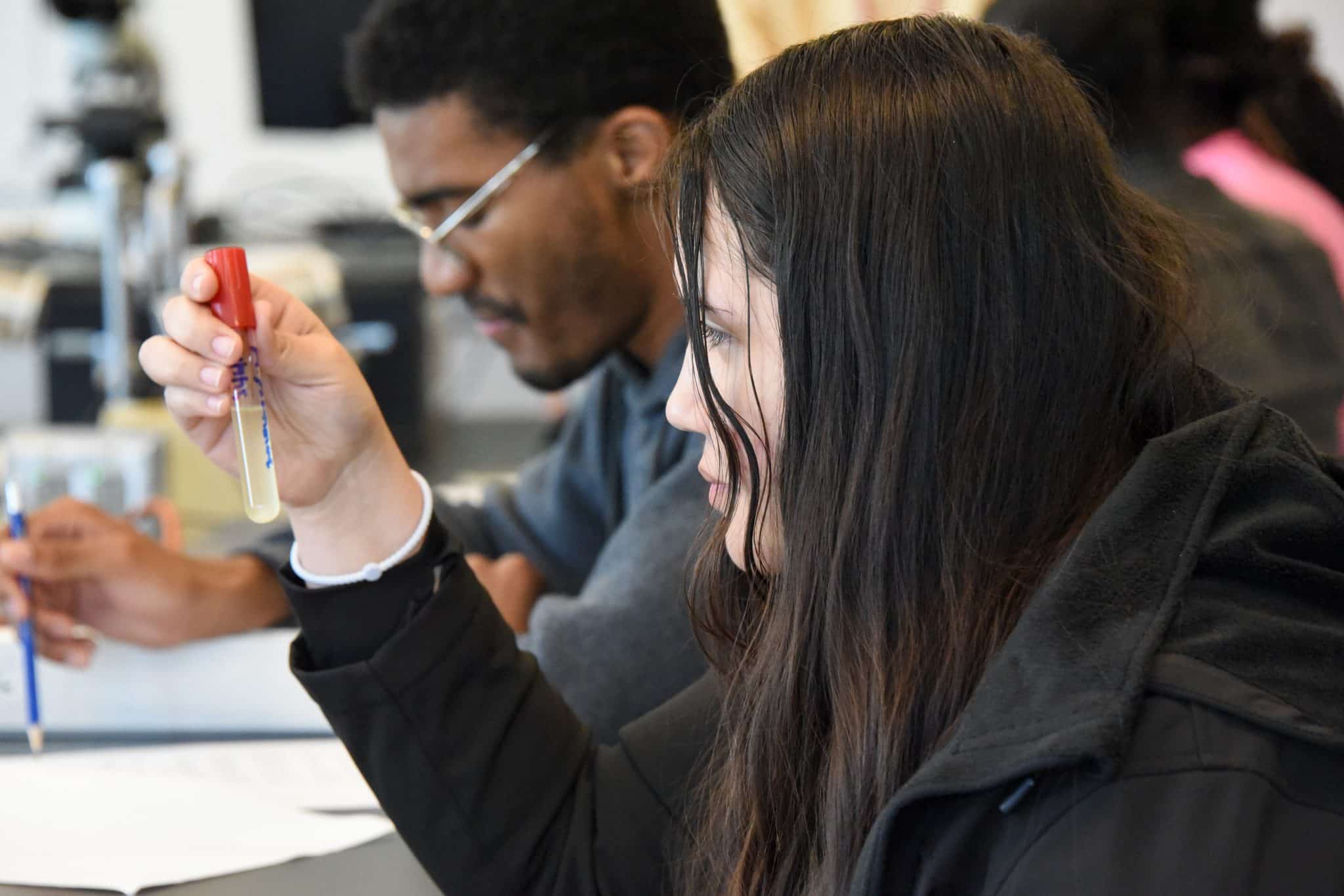 Student holding a test tube in a science class at Auburn University at Montgomery.