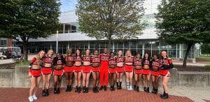 AUM Cheer smiles outside of NCA Camp.
