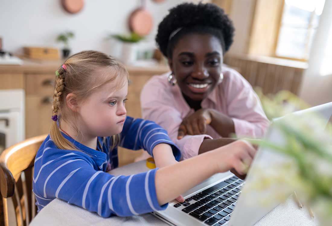 Young teacher working with a special needs child