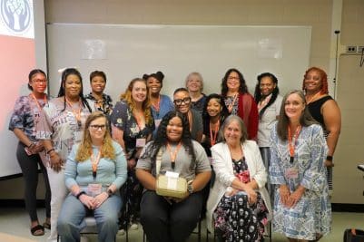 Group of women posing for a photo in a classroom setting at Auburn University at Montgomery.