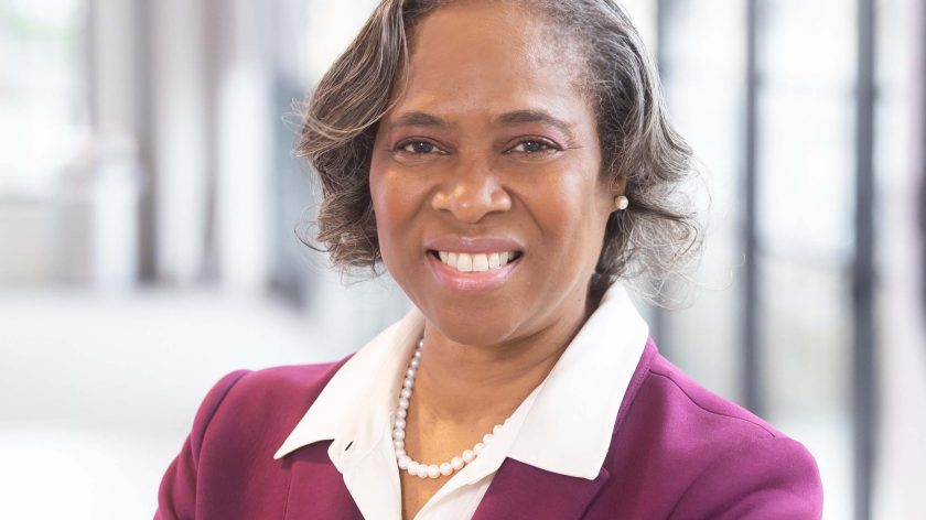 A Person In A Professional Suit Smiling At Auburn University At Montgomery Campus.