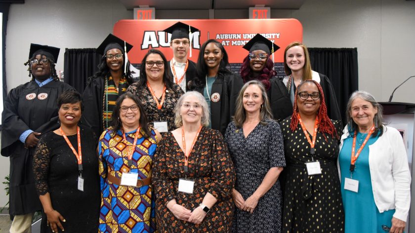 A Group Of Graduates And Faculty Smiling At An Auburn University At Montgomery Event.