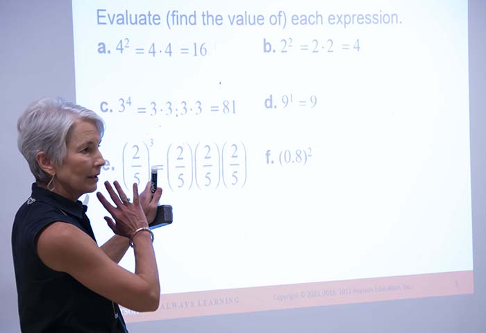 A woman teaching math concepts on a screen at Auburn University at Montgomery.