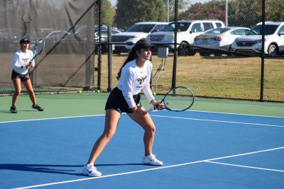 Auburn University at Montgomery women's tennis players in action on the court.