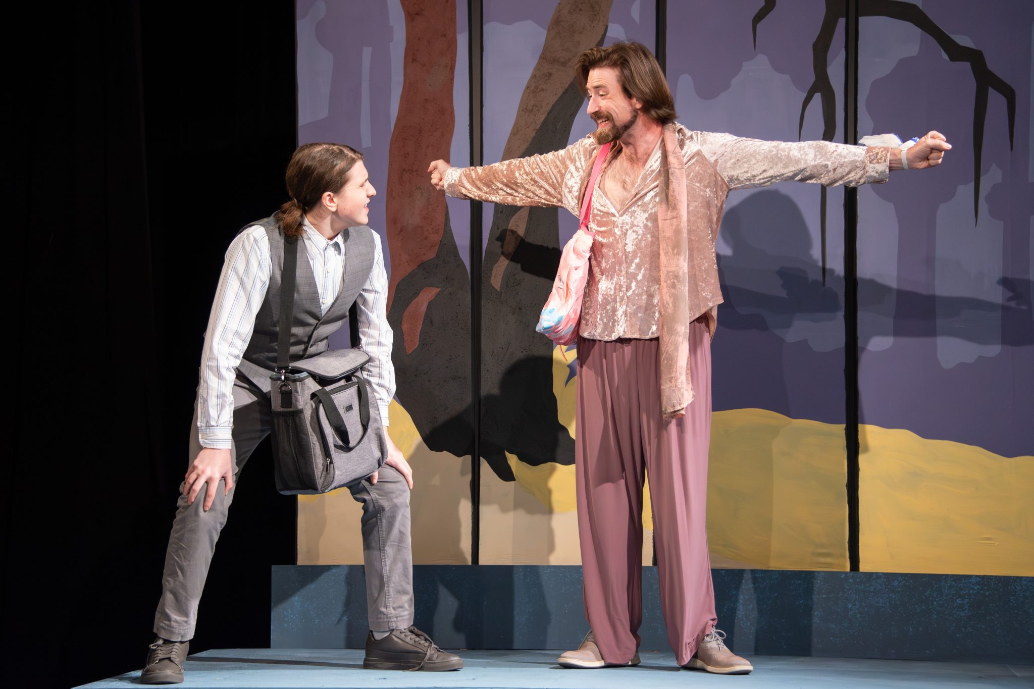 Two actors performing energetically on stage at Auburn University at Montgomery.