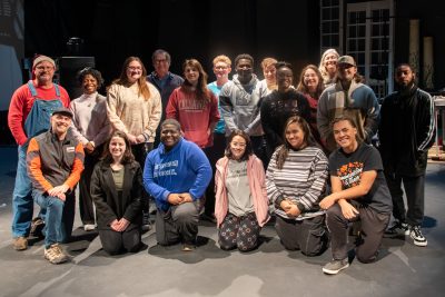 Group of students and faculty posing on stage at Auburn University at Montgomery.