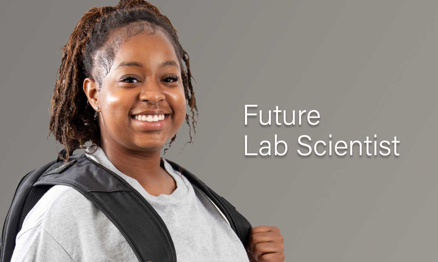 Auburn University at Montgomery student smiling with backpack; text reads Future Lab Scientist promoting AUM STEM.