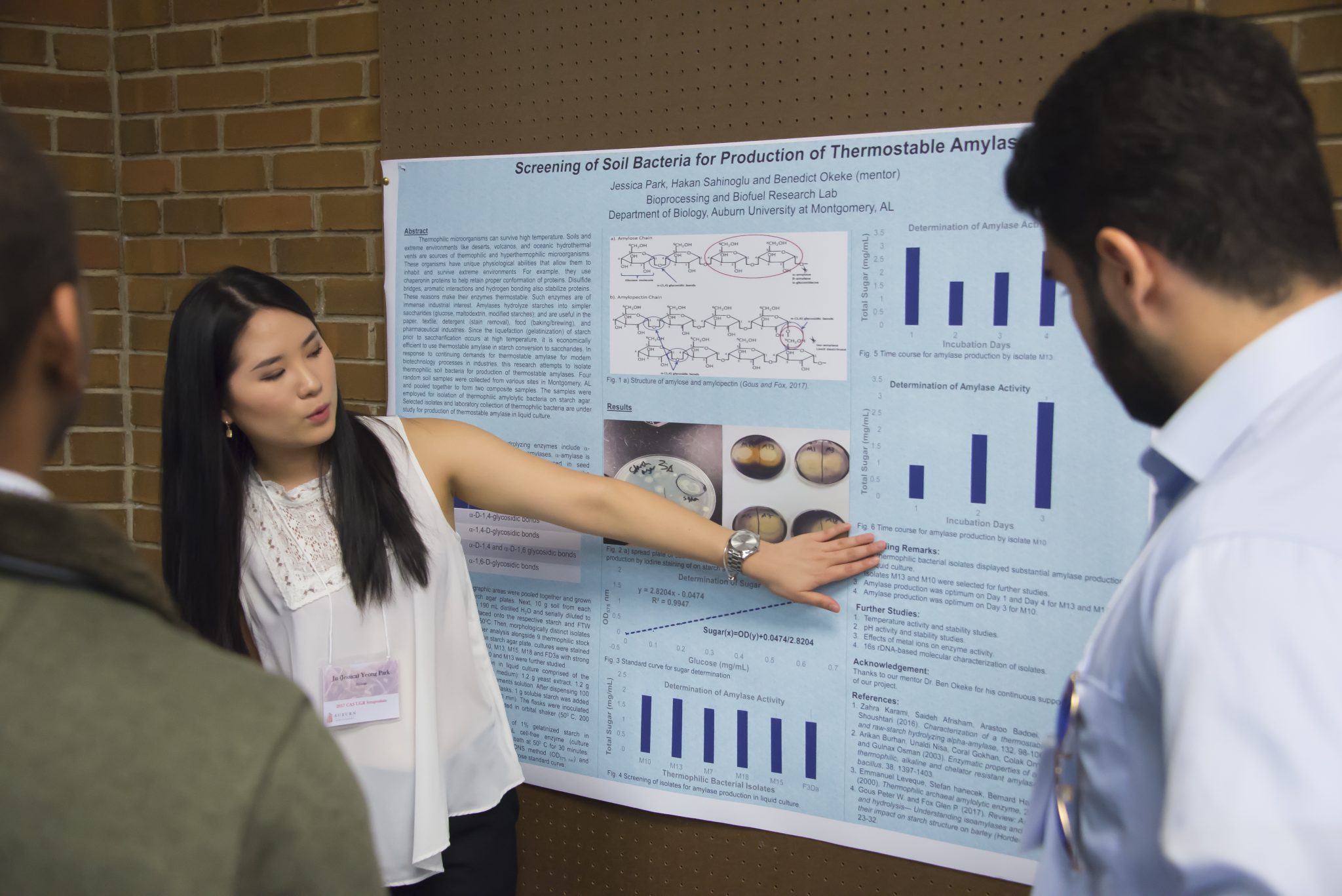 Auburn University at Montgomery student presents biology research poster on thermostable amylase to peers at symposium.
