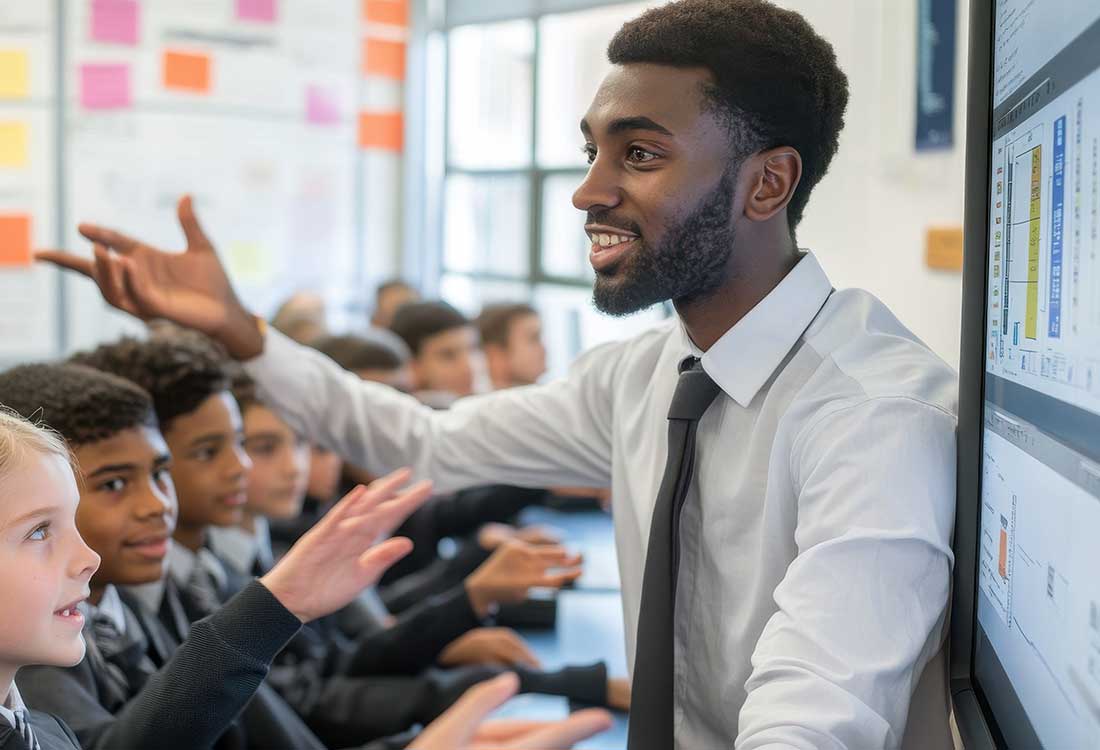 Auburn University at Montgomery classroom: a man teaches students using an interactive screen, encouraging hands-on learning.