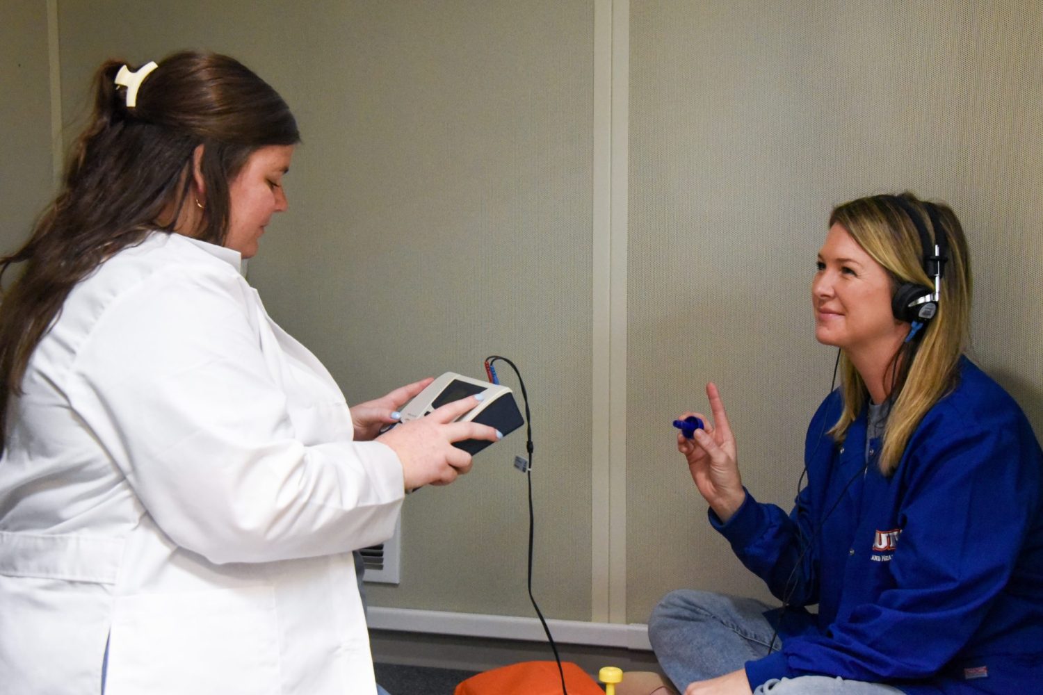 Auburn University At Montgomery Audiology Lab: A Technician Conducts A Hearing Test As A Person Responds Wearing Headphones