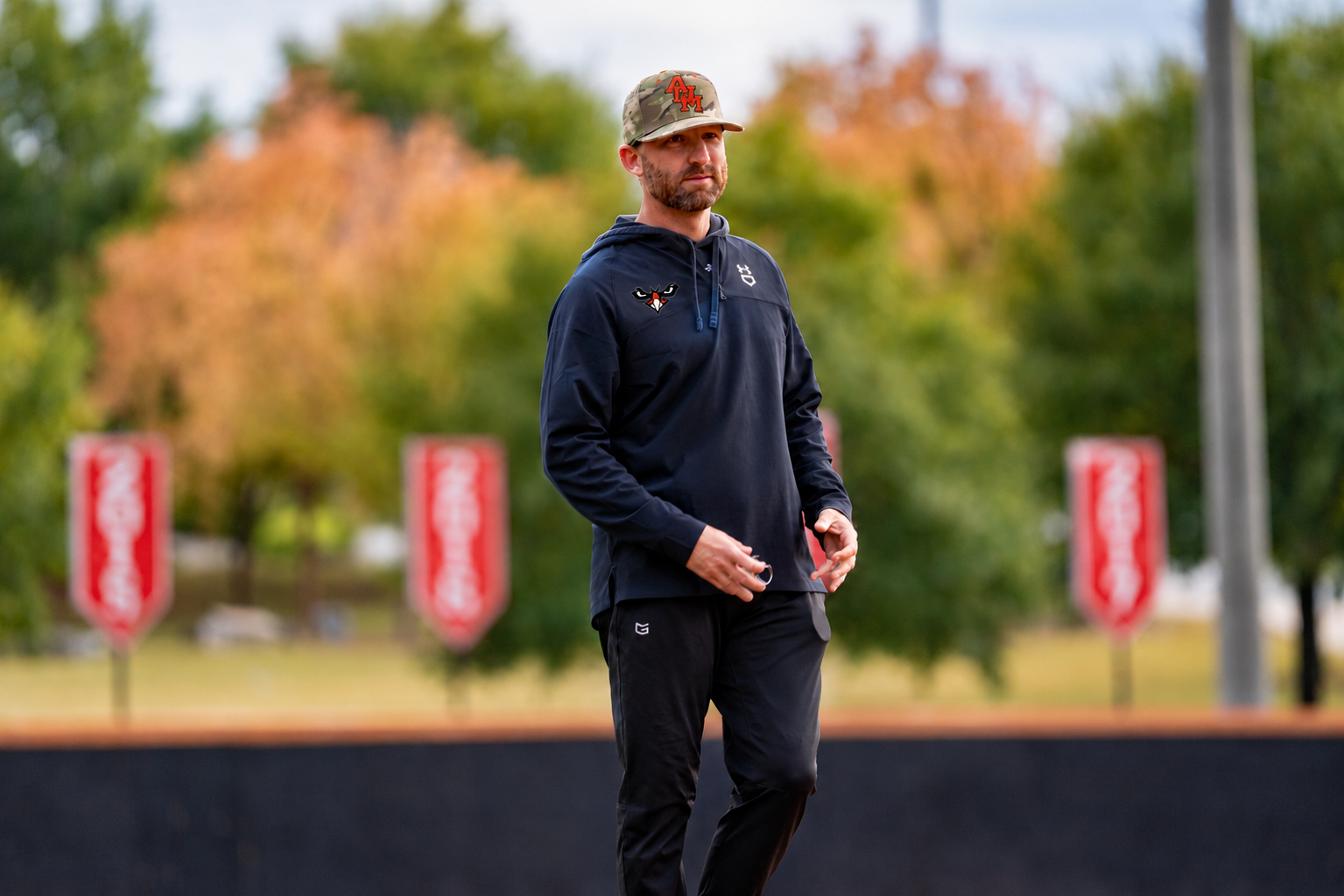 A person in AUM cap on the baseball field at Auburn University at Montgomery during Warhawks practice in fall.