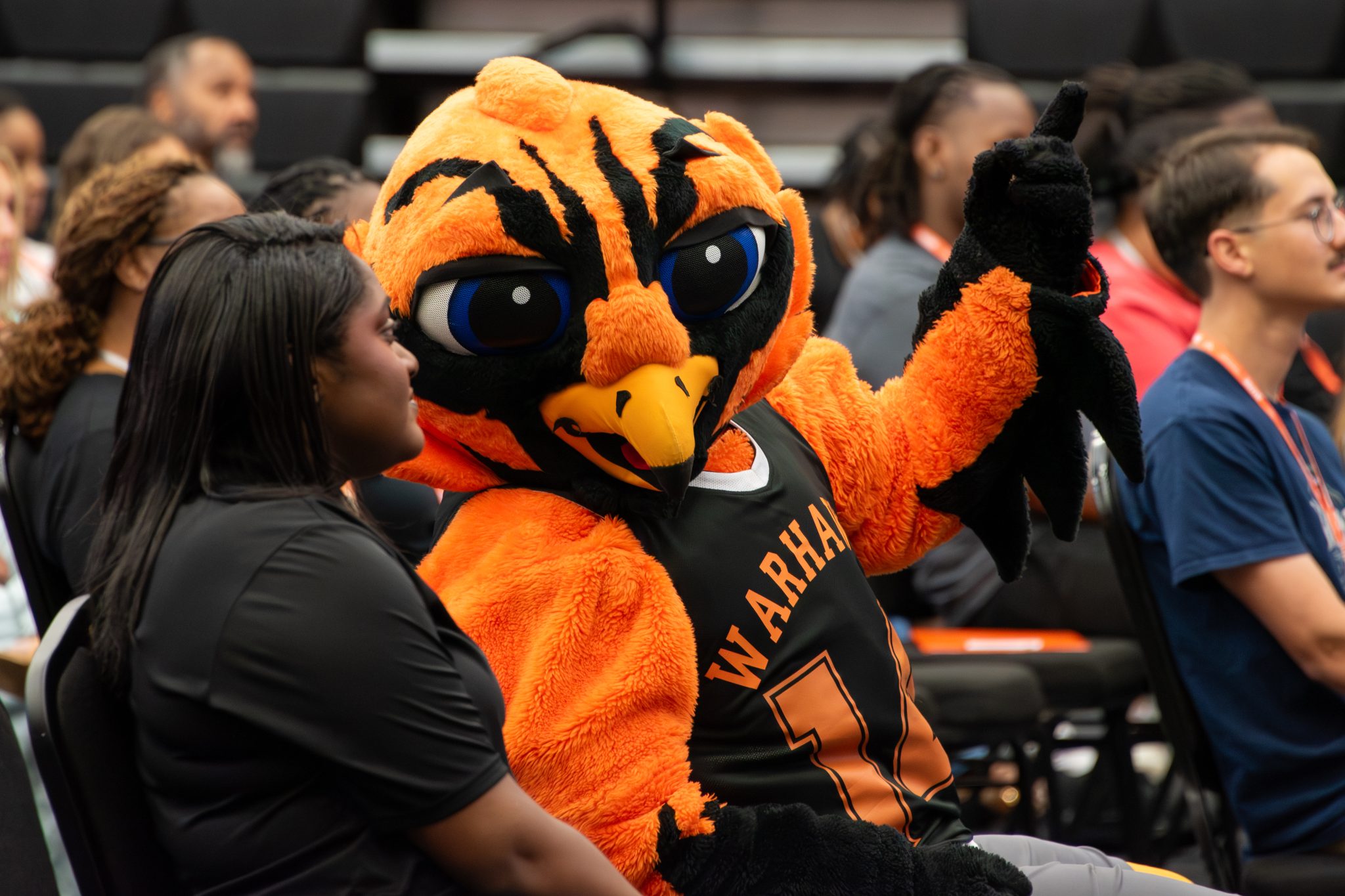 Auburn University at Montgomery Warhawks mascot, Curtiss, chats with a student at fall orientation.