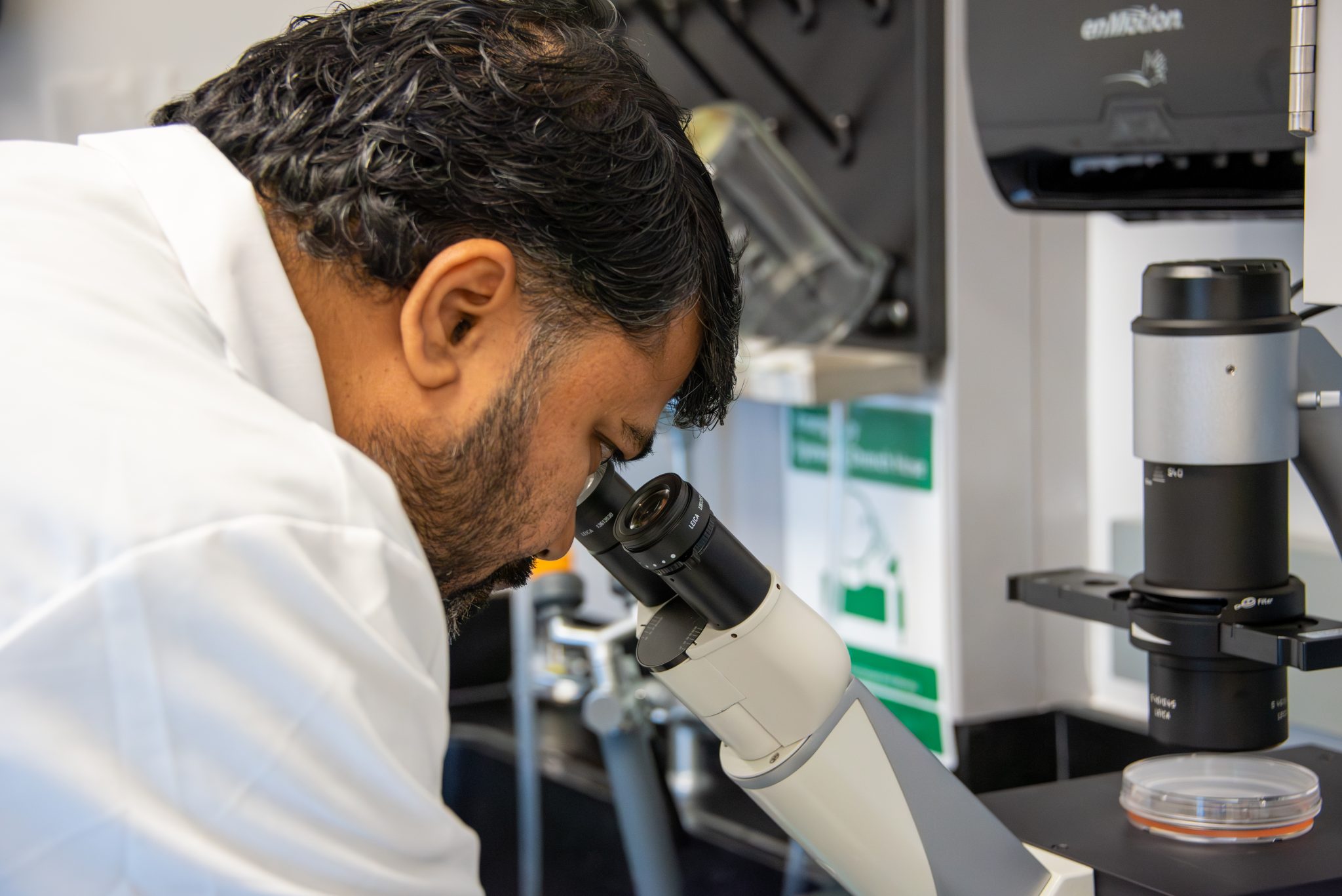 A person in an AUM biology lab using a microscope for research at Auburn University at Montgomery