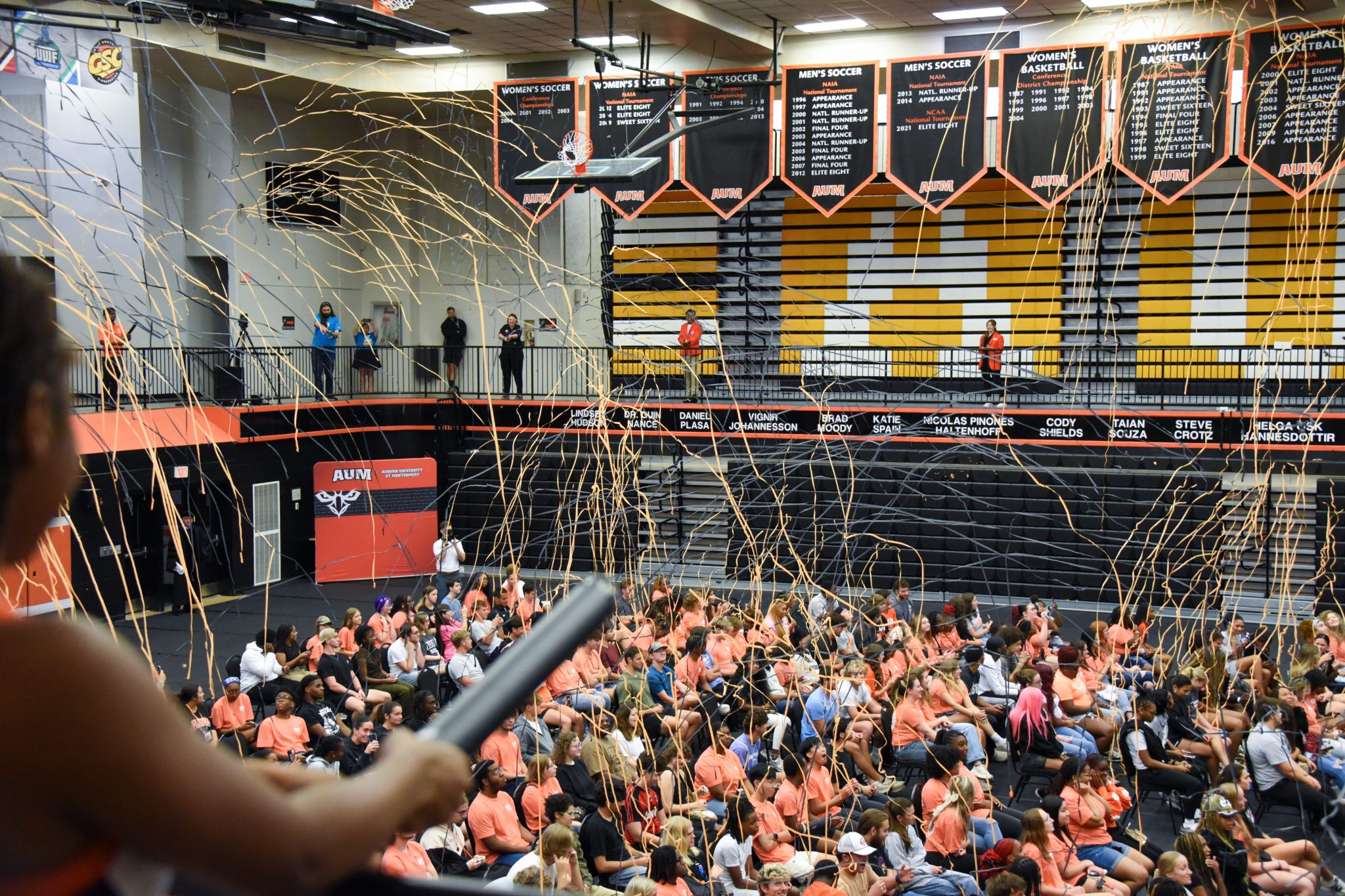 Auburn University at Montgomery students celebrate in the gym with streamers during AUM New Student Convocation.