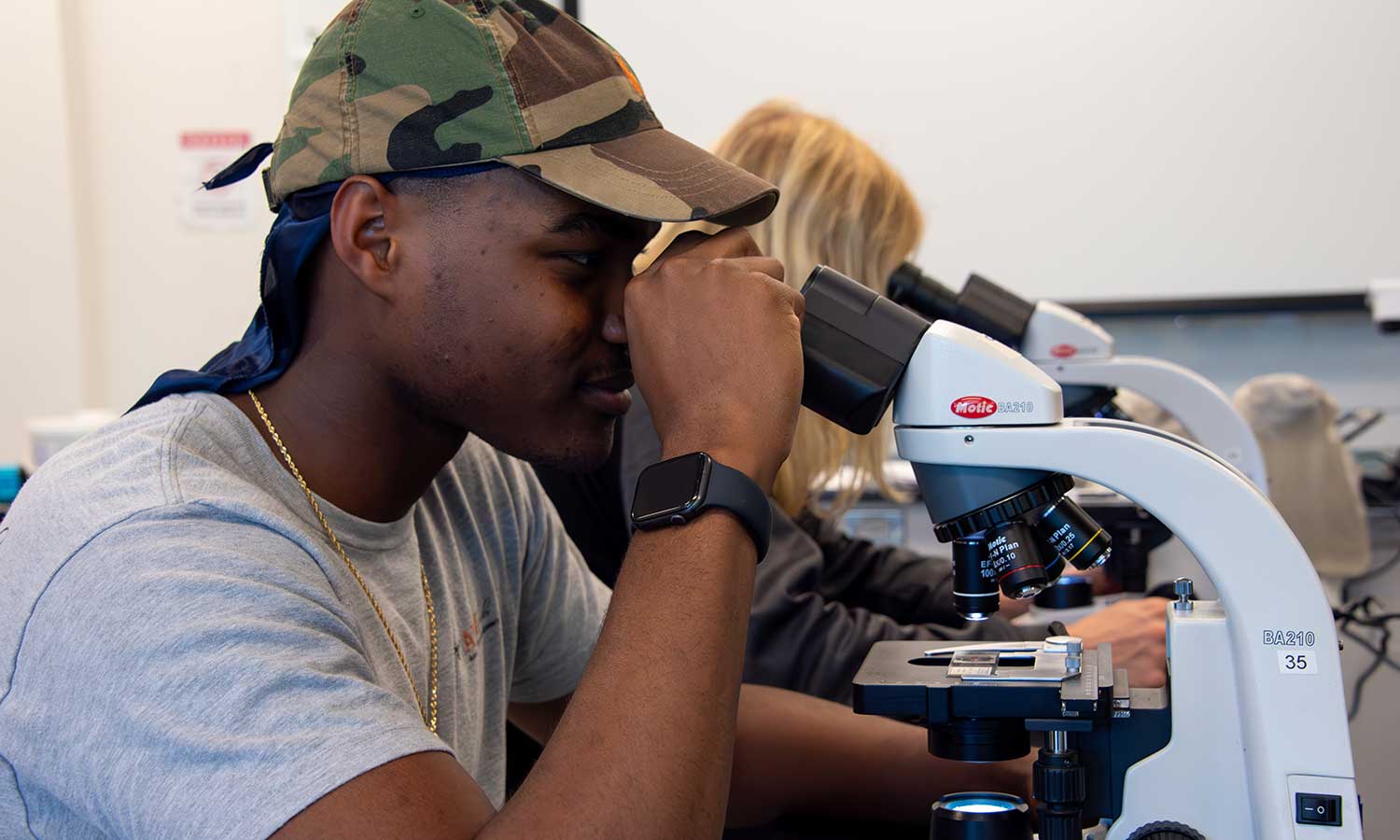 AU-Pharm-AUM-Biology Auburn University at Montgomery student using a microscope in a biology lab classroom