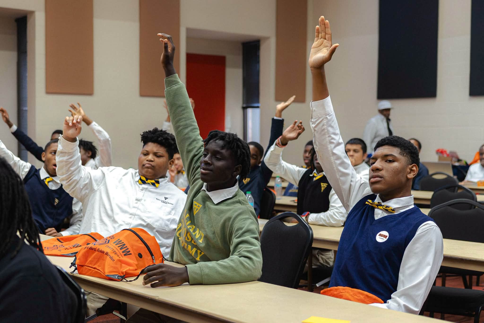 Auburn University at Montgomery classroom: students in uniforms raising hands during a lecture and discussion