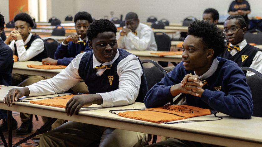 Auburn University At Montgomery Students In A Classroom, Talking During A Workshop With Orange AUM Bags On Tables