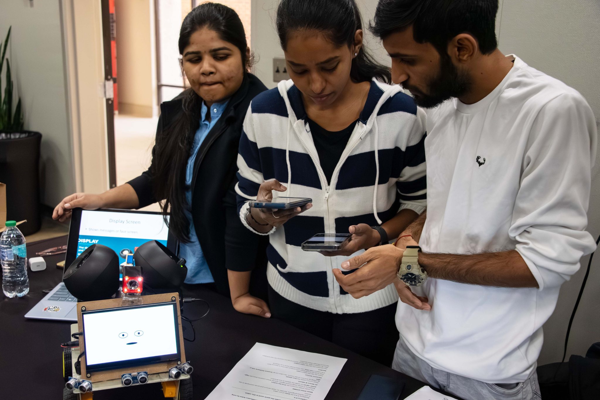 Auburn University at Montgomery students test a smartphone-controlled robot at a campus engineering showcase